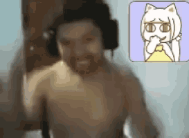 a shirtless man wearing headphones is standing in front of a cartoon of a cat .