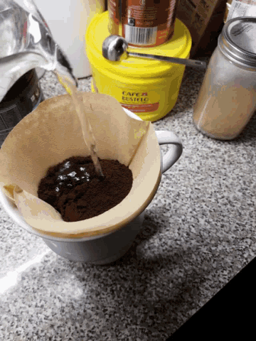 a yellow bucket that says cafe & bistro on it sits on a counter
