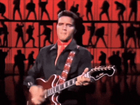 elvis presley is playing a guitar on stage in front of a crowd