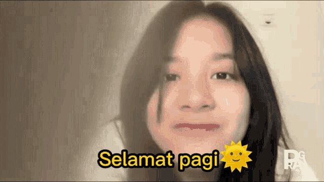 a girl says selamat pagi with a sun in the background