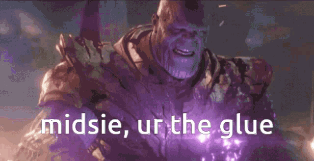 thanos from the movie avengers endgame is holding a purple object in his hands .