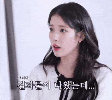 a woman with korean writing on her face looks at the camera