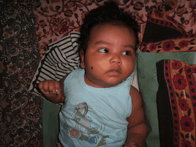 a baby wearing a blue shirt that says ' i love you ' on it