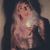 a woman is smoking a cigarette with smoke coming out of it
