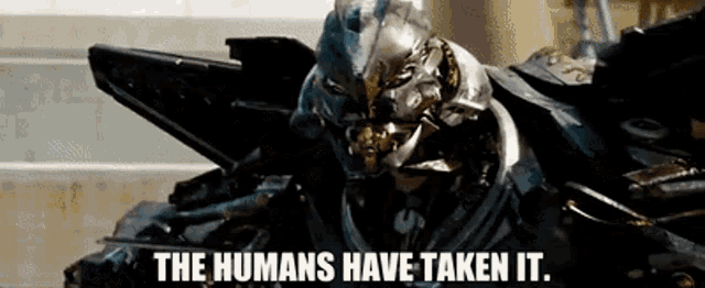 a robot with the words " the humans have taken it " written on it