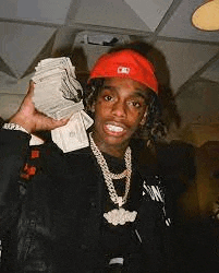 a man wearing a red hat and holding a stack of money .