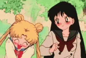 a couple of anime girls are standing next to each other in a park .