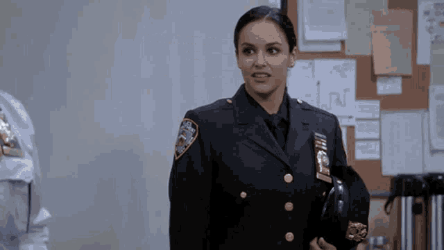 a woman in a police uniform with a patch that says nypd on it
