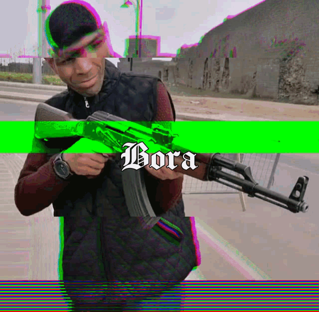 a man is holding a gun with bora written on the bottom