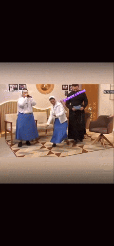 two nuns singing into microphones in a living room