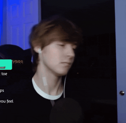 a person wearing ear buds holds their hair in front of a screen that says " you feel "
