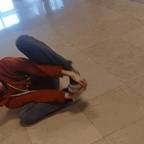 a person wearing a red hoodie with the letter a on it