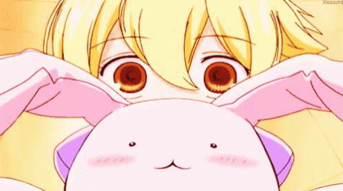 a close up of a girl holding a stuffed animal with bunny ears