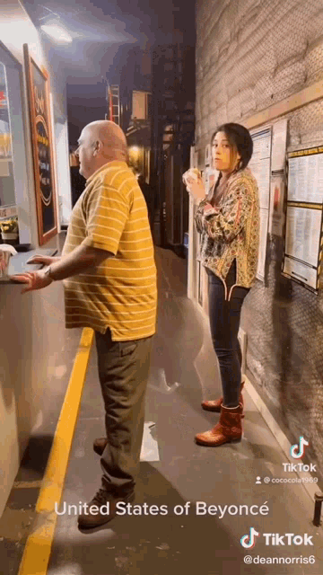a man and a woman are standing in a hallway in the united states of beyonce