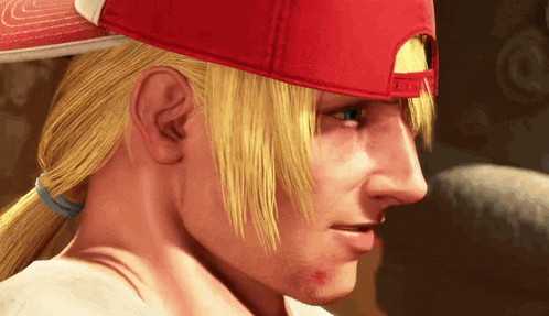 a close up of a man 's face wearing a red baseball cap