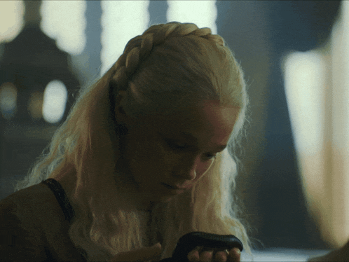 a woman with blonde hair has a braided headband