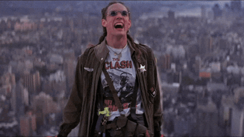 a man wearing a shirt that says the clash is screaming