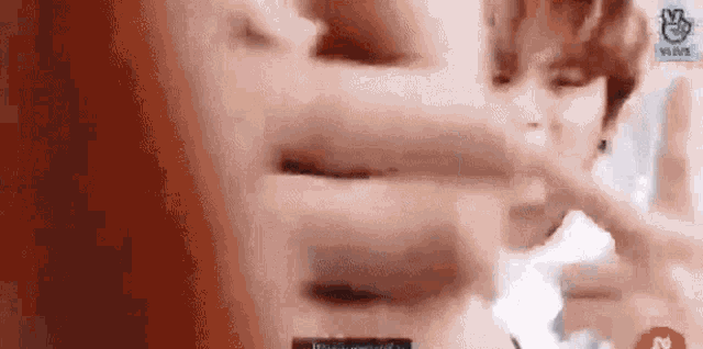 a close up of a person 's face with a blurry background and a blurred image of their face .