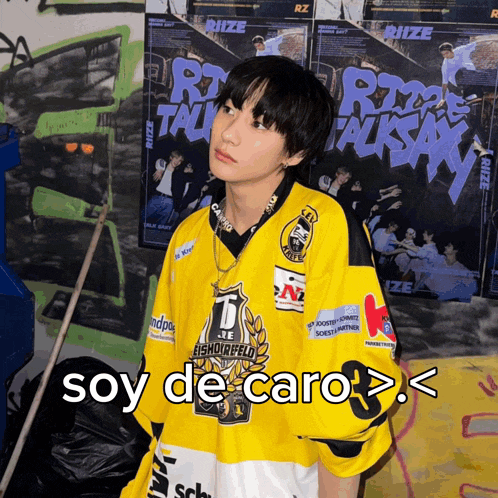 a boy wearing a yellow jersey with the words soy de caro on it