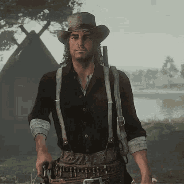 a man wearing suspenders and a cowboy hat holds a gun
