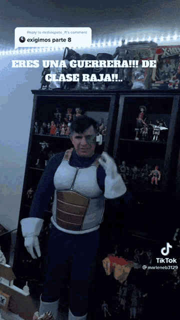 a man in a superhero costume is standing in front of a display case of action figures