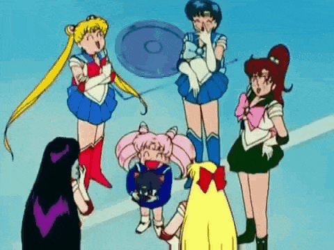 a group of sailor moon characters are standing next to each other .