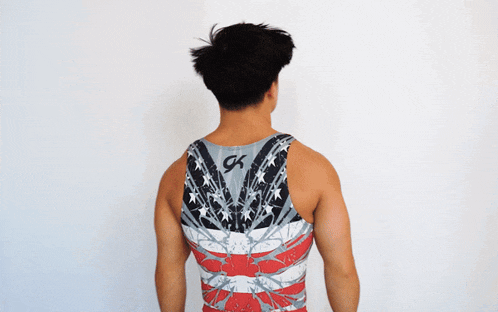 the back of a man wearing a tank top that says gk