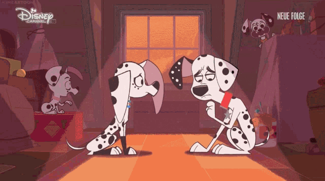 two dalmatian dogs are sitting next to each other with a disney channel logo in the corner