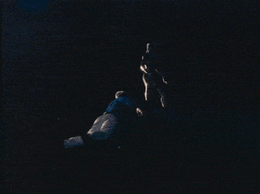 a blurred image of a person dancing in a dark room