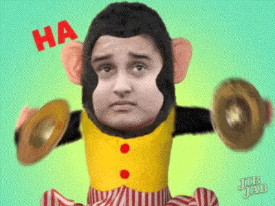 a man in a monkey costume is holding a pair of drums