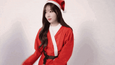 a woman in a santa claus outfit is dancing
