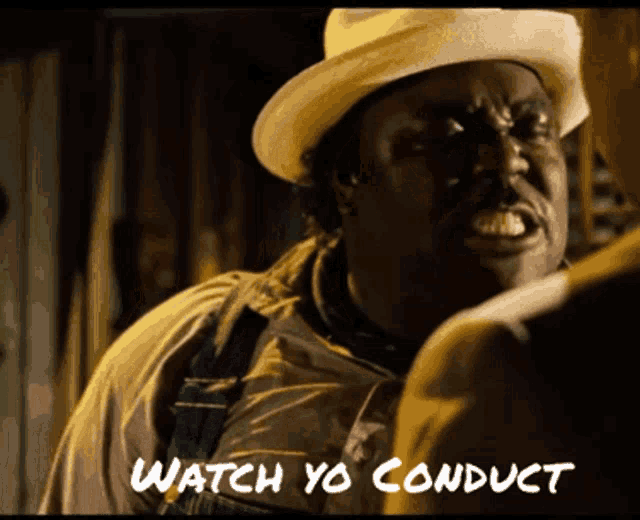 a man wearing a hat and overalls says watch yo conduct