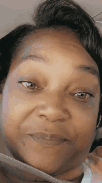 a close up of a woman 's face with a smile on her face .