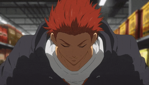 a man with red hair is wearing a black hoodie in a store