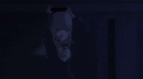 a person is standing in a dark room holding a sword .