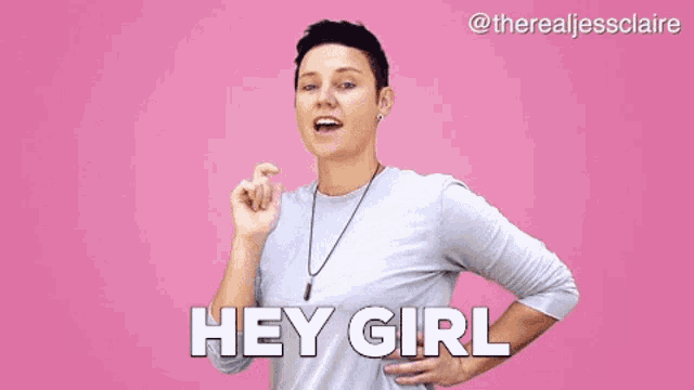 a woman is standing in front of a pink background with her hands on her hips and says hey girl .