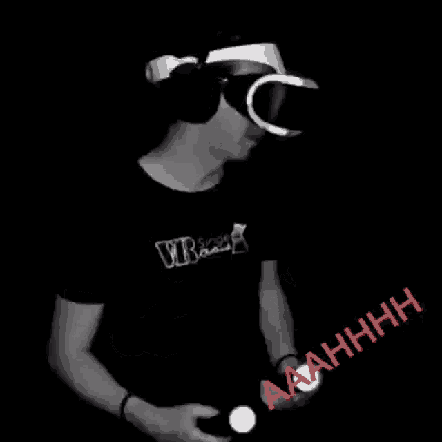 a black and white photo of a person wearing a virtual reality headset and holding a pair of controllers