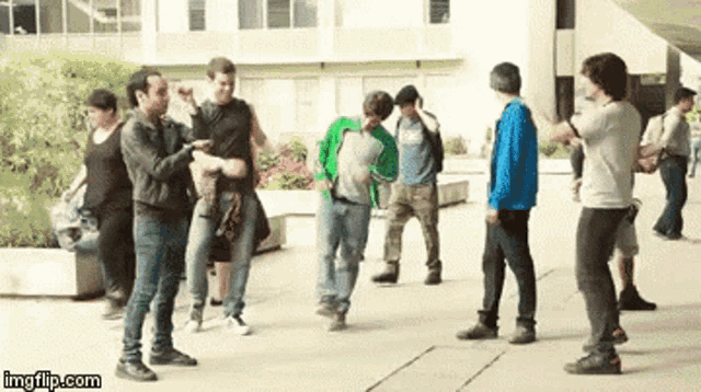 a group of people are standing in front of a building with imgflip.com in the lower right corner