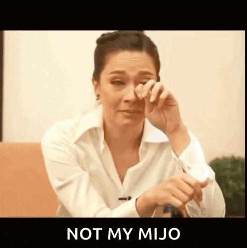 a woman in a white shirt is crying and the words not my mijo are above her .