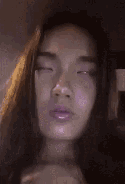 a close up of a woman 's face with her eyes closed .
