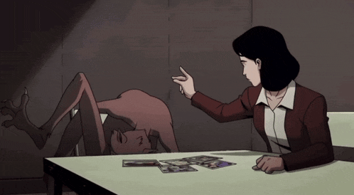a woman is sitting at a table with a monster on it