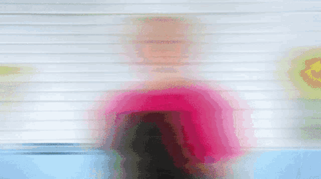 a blurry image of a person in a red shirt