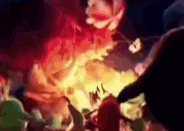 a blurry picture of a person standing in front of a large fire