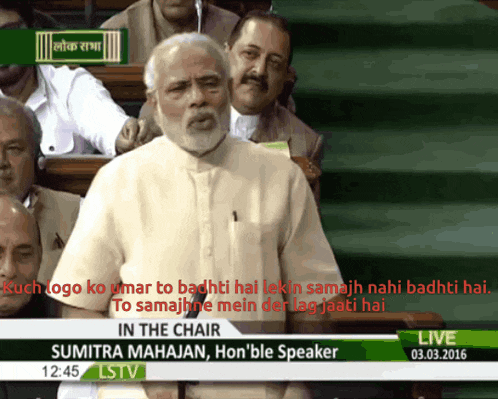 a man stands in front of a screen that says in the chair on it