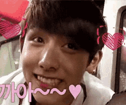 a close up of a young man 's face with hearts around his head and the words i love you