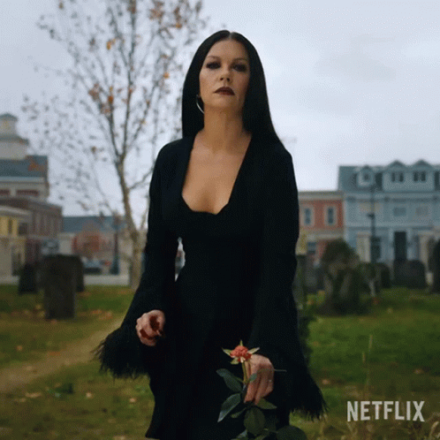 Tossing Flower Morticia Addams GIF - Tossing Flower Morticia Addams Catherine Zeta Jones GIFs