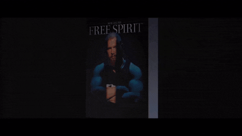 a man with a beard is standing in front of a sign that says " free "