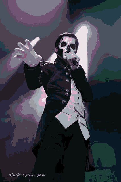 a man in a tuxedo and white gloves sings into a microphone with the name john son written below him