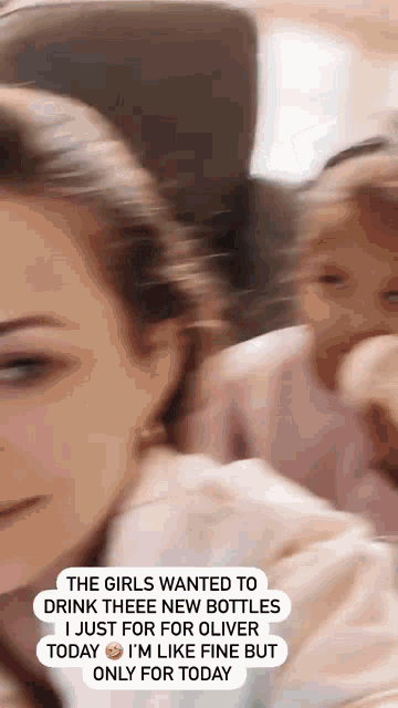a woman is holding a baby and says " the girls wanted to drink theeee new bottles