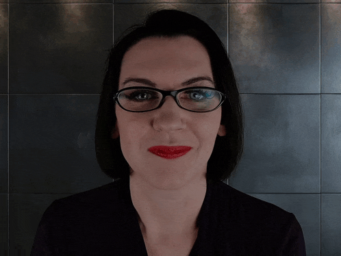 a woman with glasses and red lipstick says " you 're dangerous "